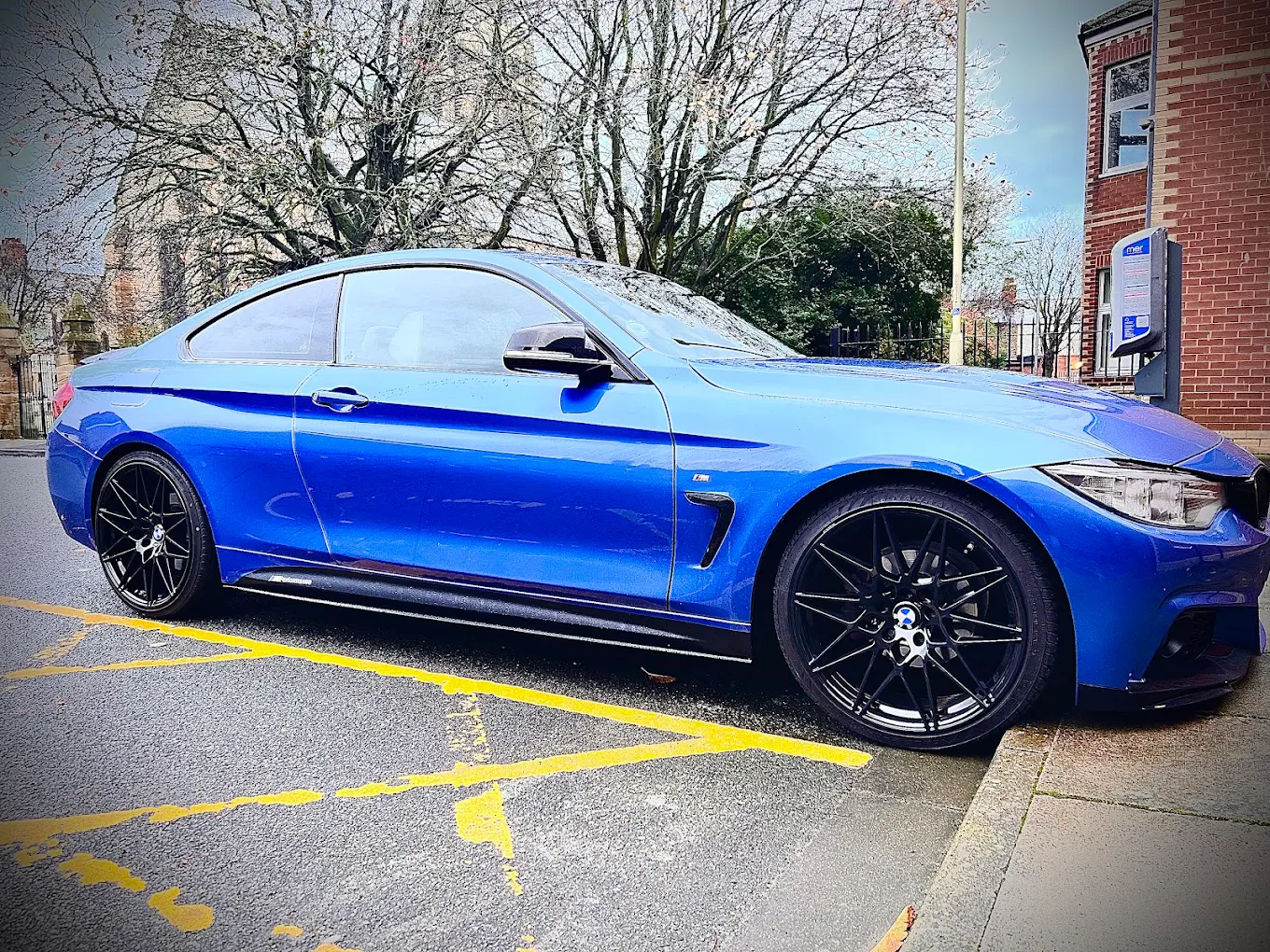 Blue BMW with gloss black alloy wheels